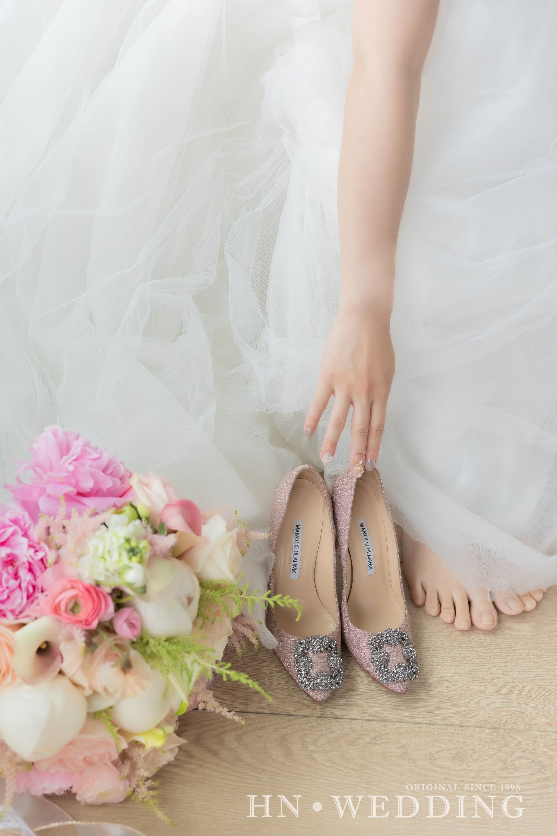 Wedding flowers beside the bride by La Rose Fleur, adding grace to the bridal ensemble