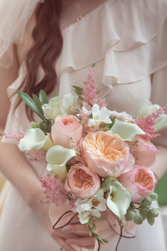 A girl holding a bridal bouquet with 51 pink flowers by La Rose Fleur