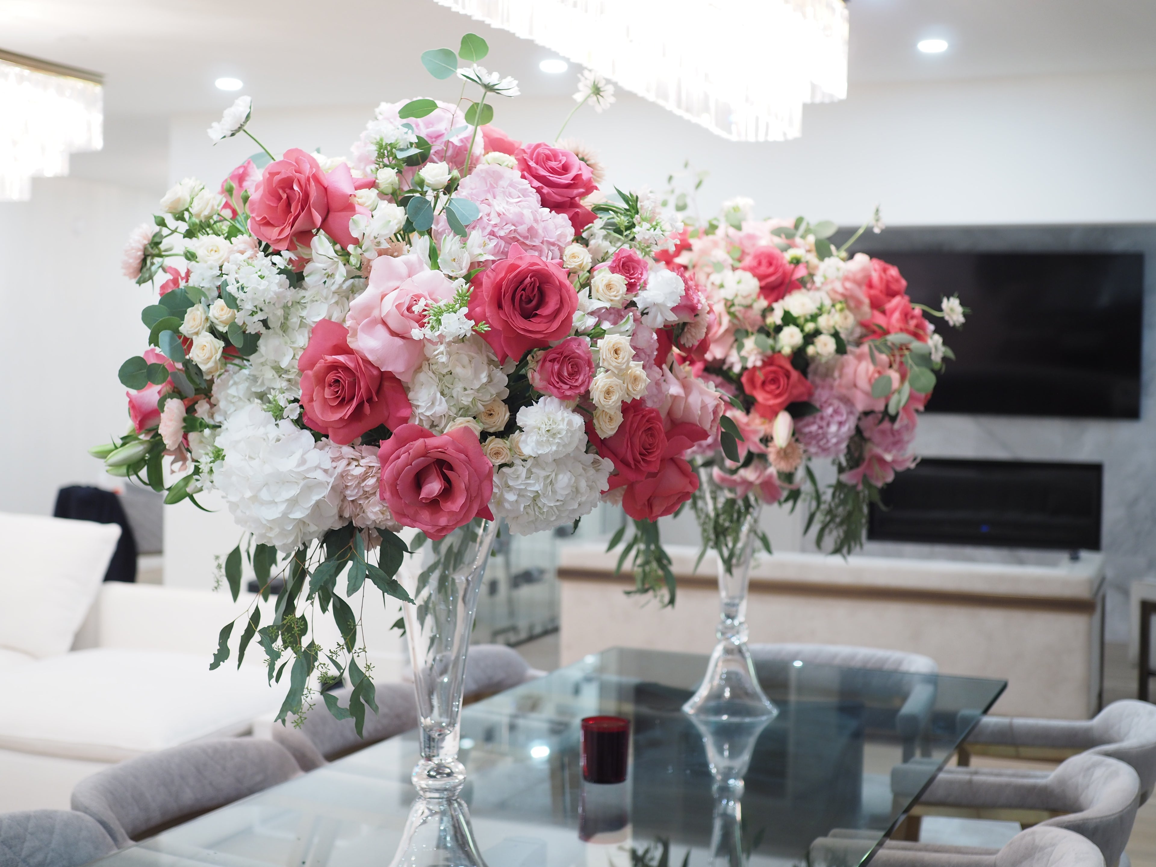 Glass vase with pink flowers by La Rose Fleur, a delightful centerpiece choice